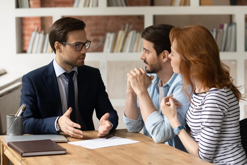 Broker discussing house deal with couple